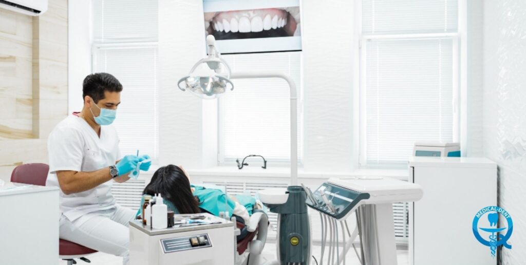 The painting depicts a dentist's surgery. A dentist wearing an apron and mask can be seen giving advice to a patient sitting in a treatment chair. A poster of dentistry hangs on the wall. The office has professional dental equipment, including a treatment lamp. The interior is decorated in light, muted colours typical of medical practices.